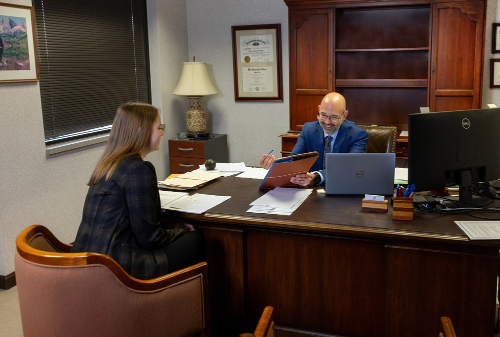 attorney smiles as he points to documents attorney smiles as he points to documents