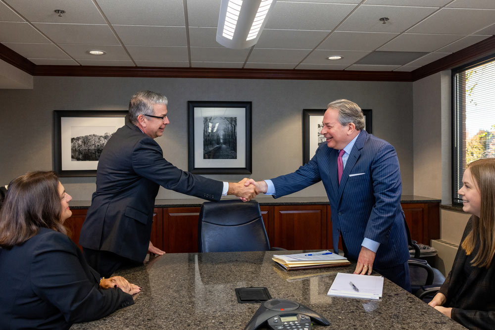 Attorneys agree on legal arrangements as they shake hands