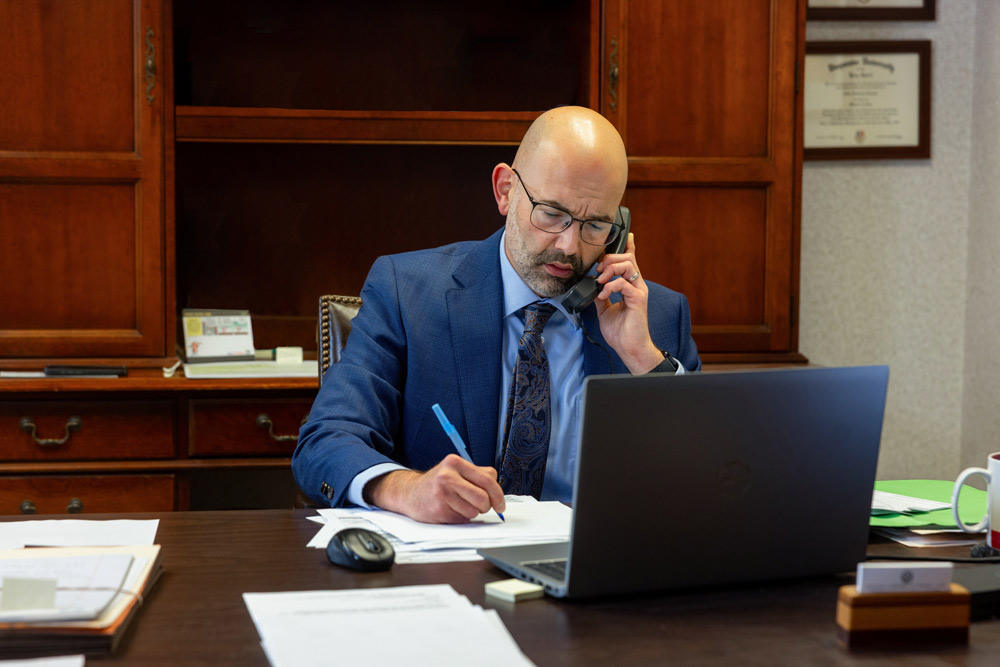 HCP Lawyer working on case Lawyer working on case talking to client on phone